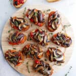 bruschetta with mushrooms and roasted peppers on a circular serving tray