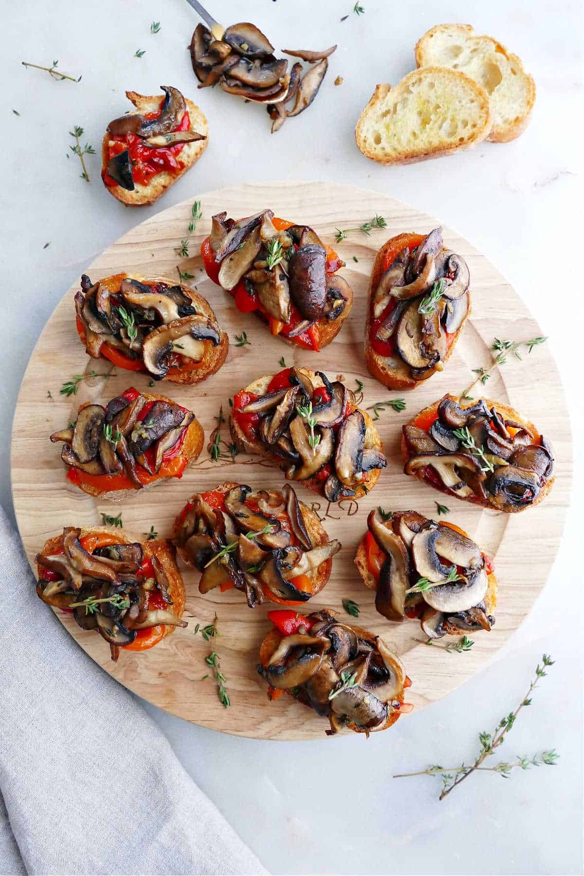 bruschetta with mushrooms and roasted peppers on a circular serving tray