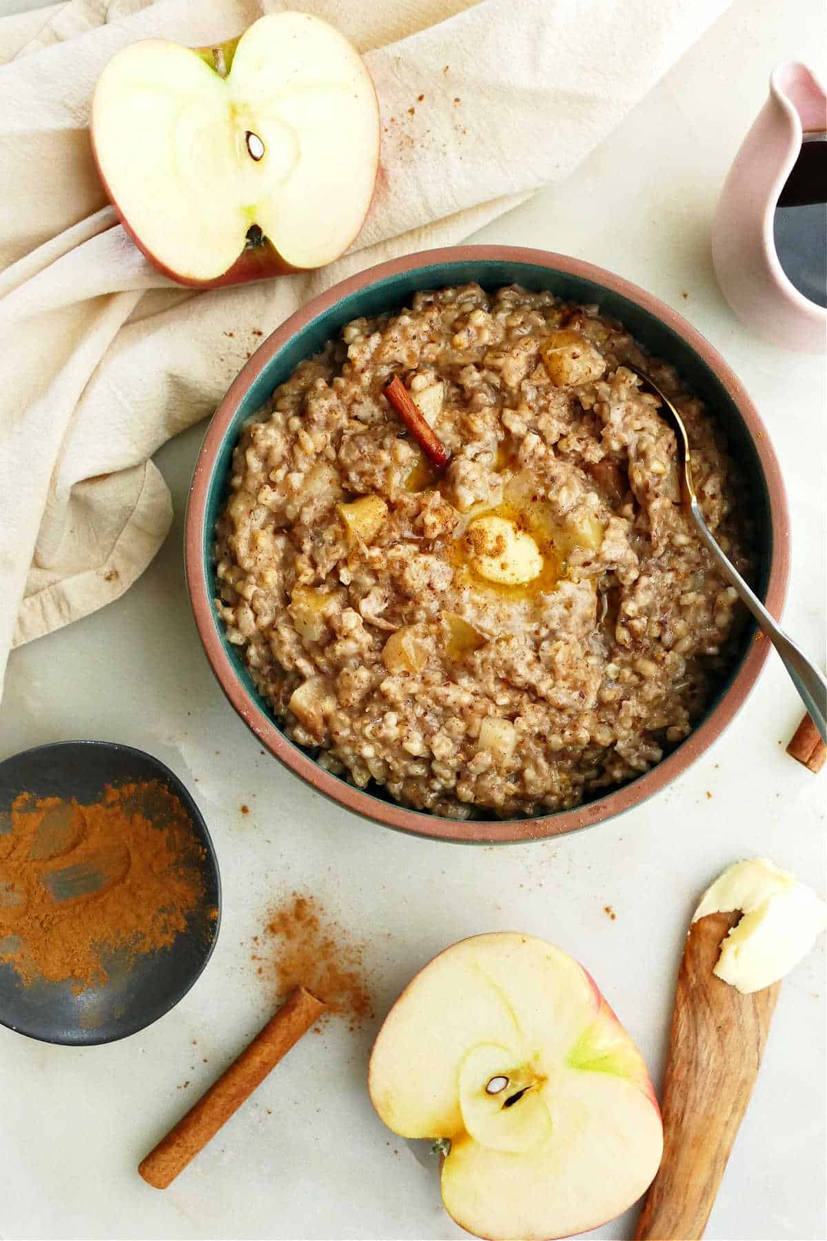 slow cooker oatmeal with apples in a bowl with a spoon on a counter