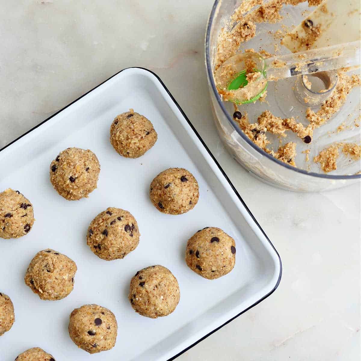 chickpea cookie dough rolled into balls and put on a tray for freezing