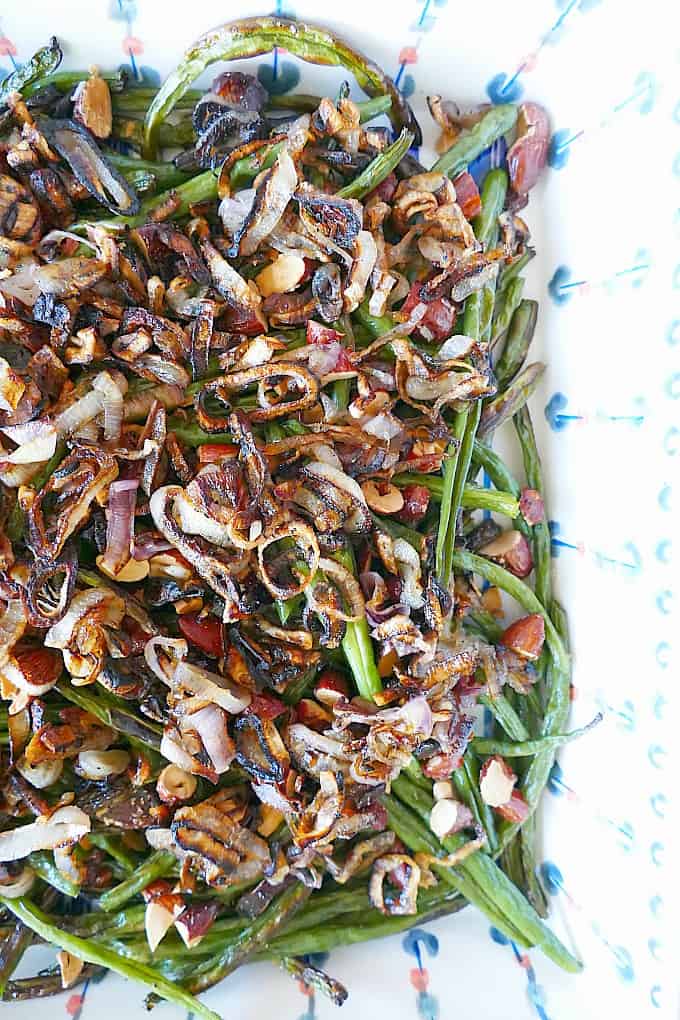Healthier green bean casserole with shallots and almonds in a serving dish