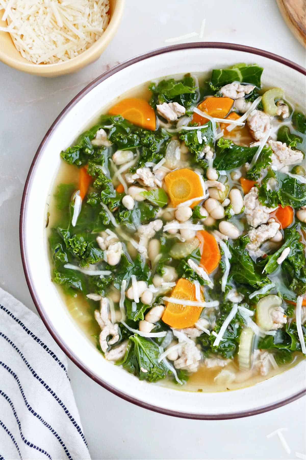 Easy and delicious slow cooker kale and white bean soup with sausage. Gluten-free and filled with vegetables!