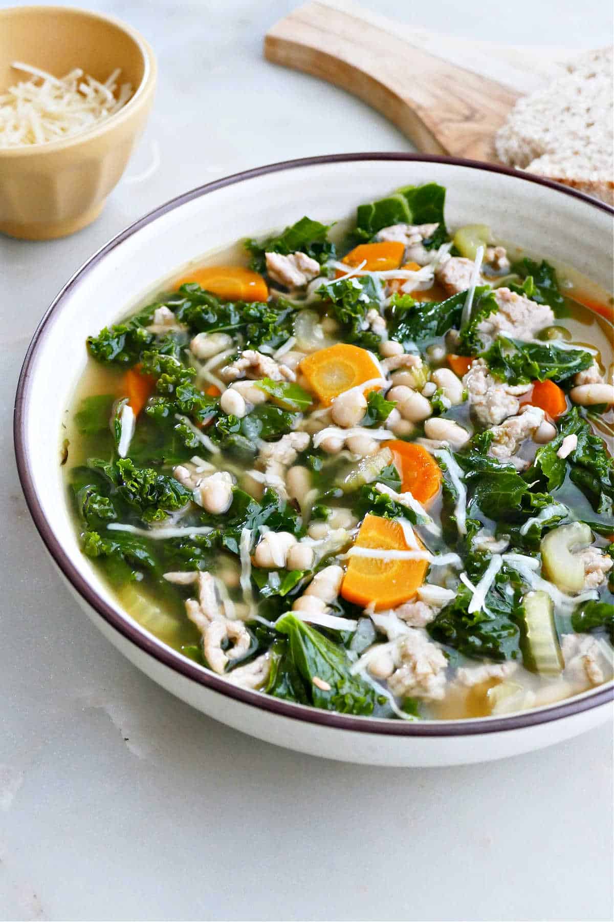 Easy and delicious slow cooker kale and white bean soup with sausage. Gluten-free and filled with vegetables!
