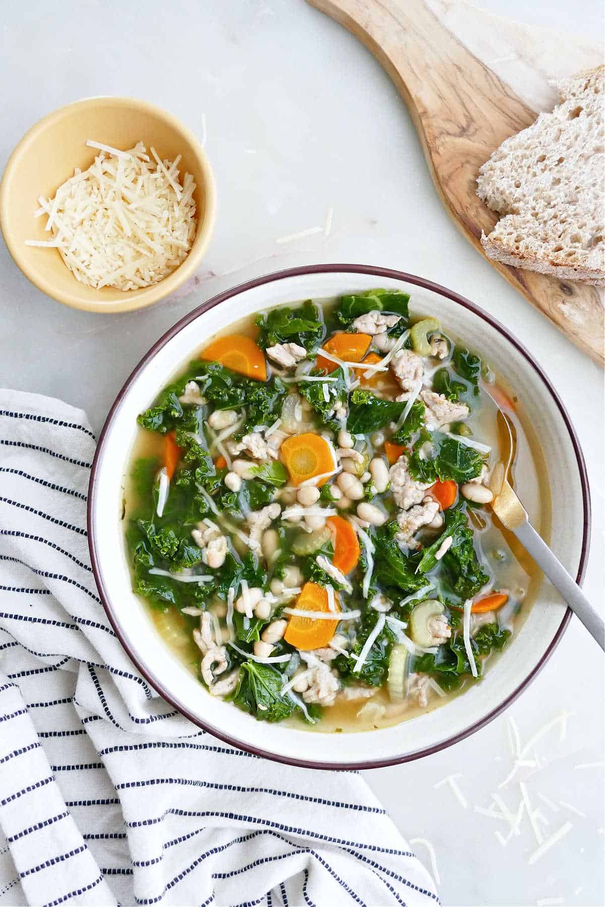 Easy and delicious slow cooker kale and white bean soup with sausage. Gluten-free and filled with vegetables!