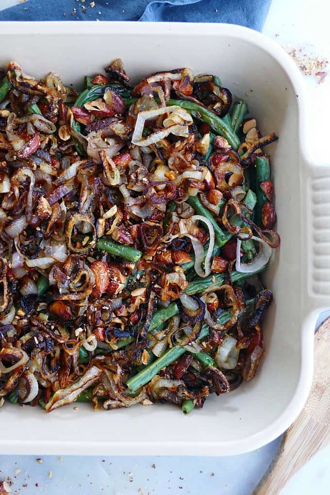 close up of green bean casserole with crispy shallots and almonds