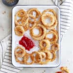 oven panko onion rings with ketchup on a tray on a napkin