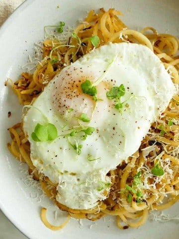 square image of rutabaga noodles topped with a fried egg in a dish