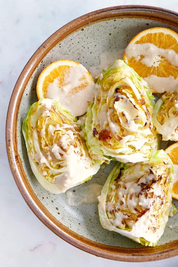 close-up of seared cabbage wedges with tahini dressing