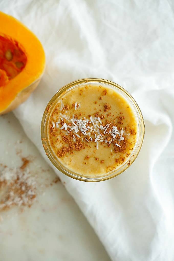 Vegan Butternut Squash Dessert Smoothie sprinkled with cinnamon and coconut on a counter