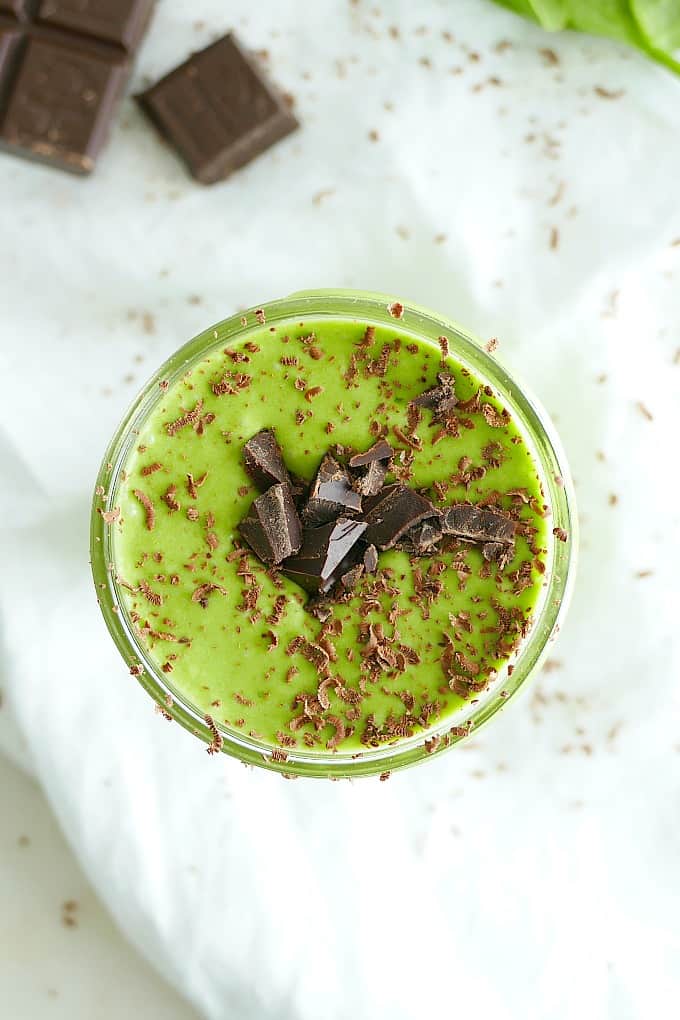 overhead shot of mint banana smoothie with chocolate shavings on a white napkin