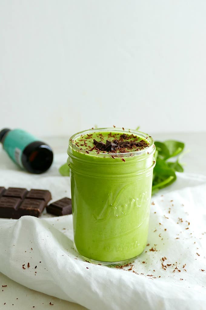 side shot of a vegan shamrock shake in a glass jar with a white background