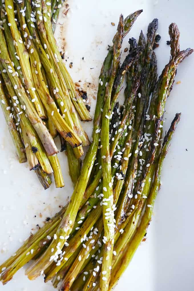 Roasted Sesame Asparagus on a serving tray topped with sesame seeds