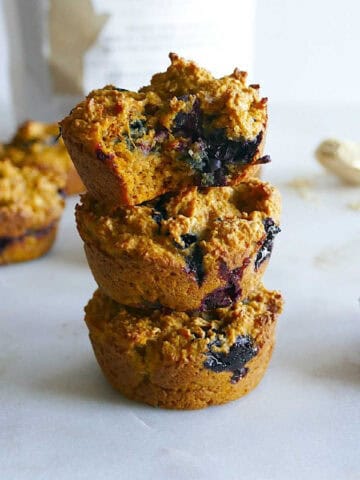 Three oatmeal sweet potato muffins stacked on top of each other.
