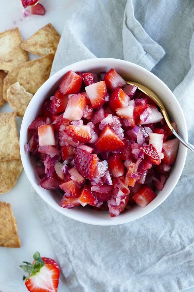 strawberry rhubarb salsa in a serving bowl with a spoon