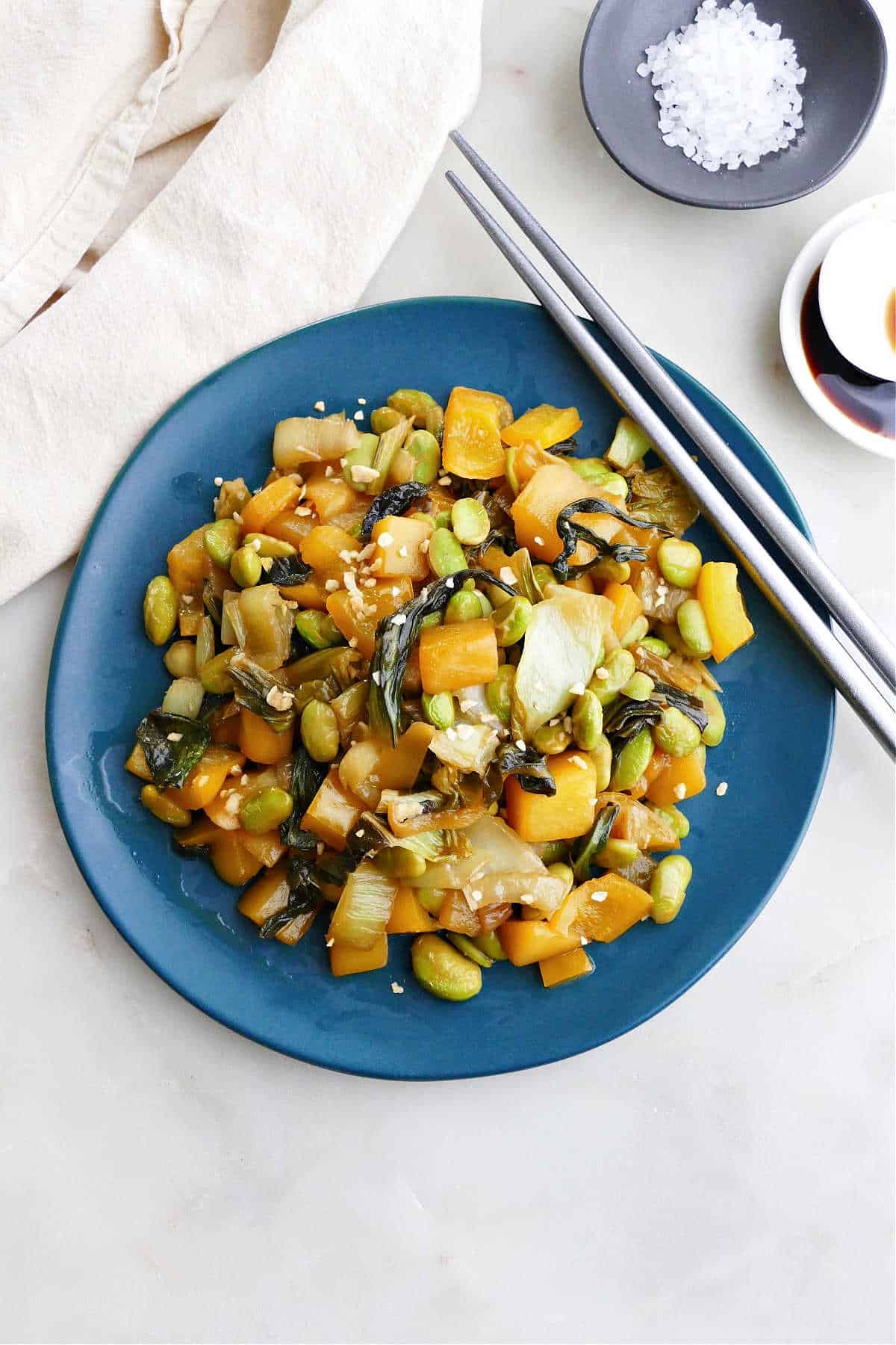 Bok Choy Mango Stir Fry on a serving plate with chopsticks resting on the edge