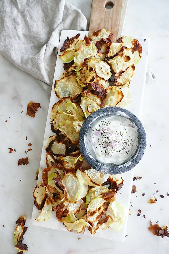 baked kohlrabi chips with shallot yogurt dip on a serving tray