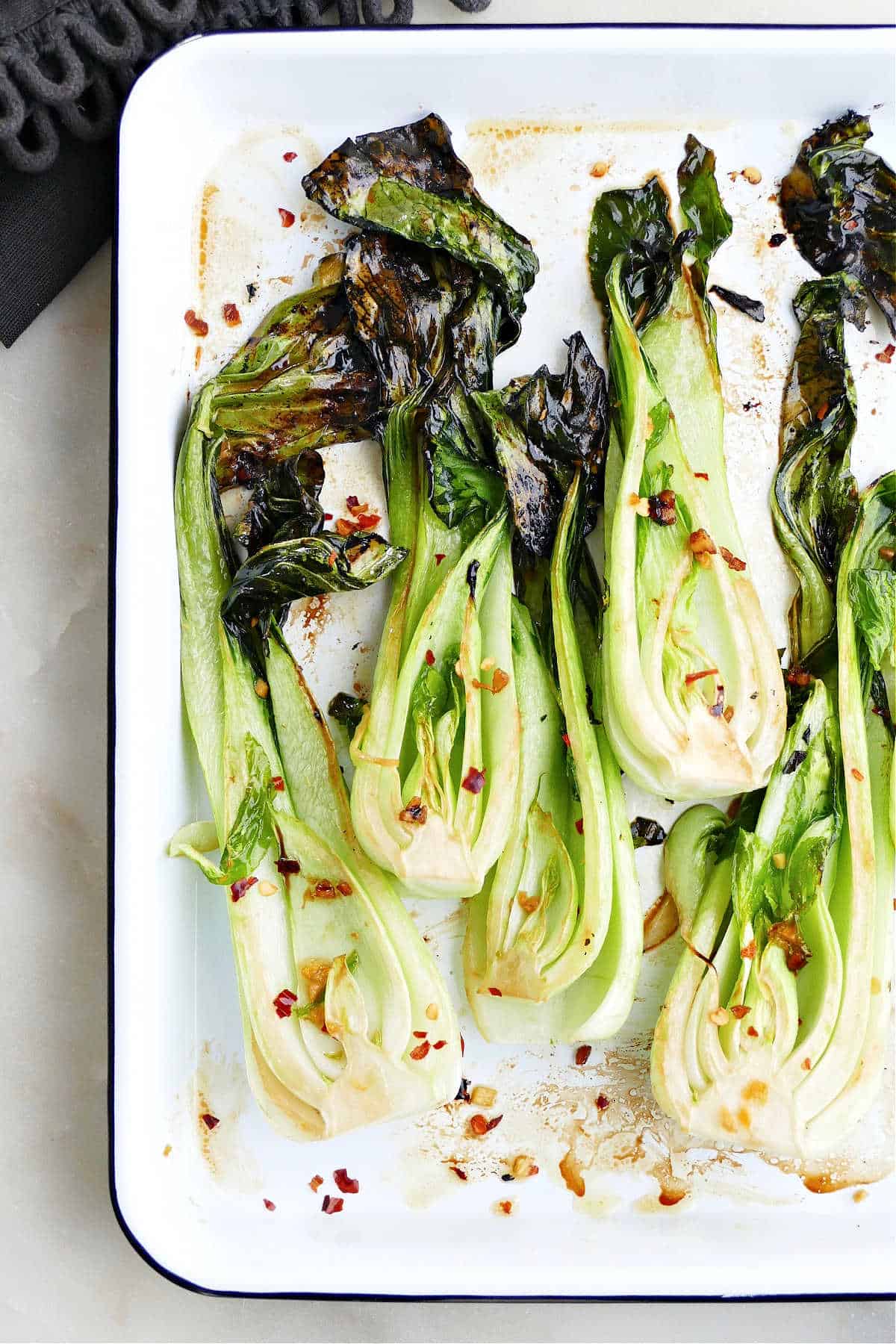 overhead image of roasted bok choy on a serving tray on a counter