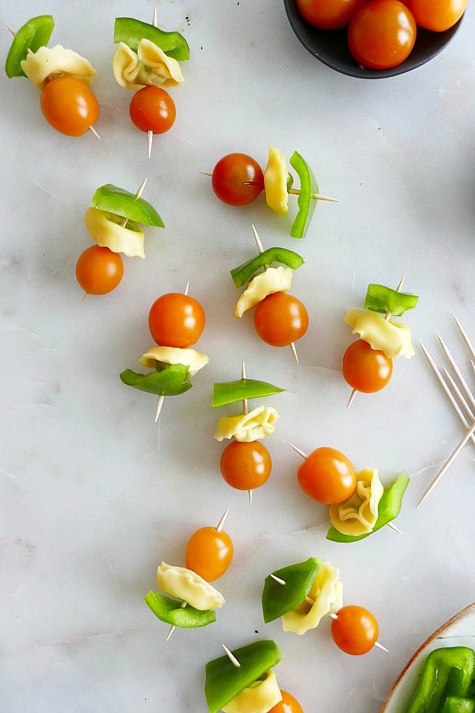 close up of 12 lunchbox skewers spread out next to each other on a counter