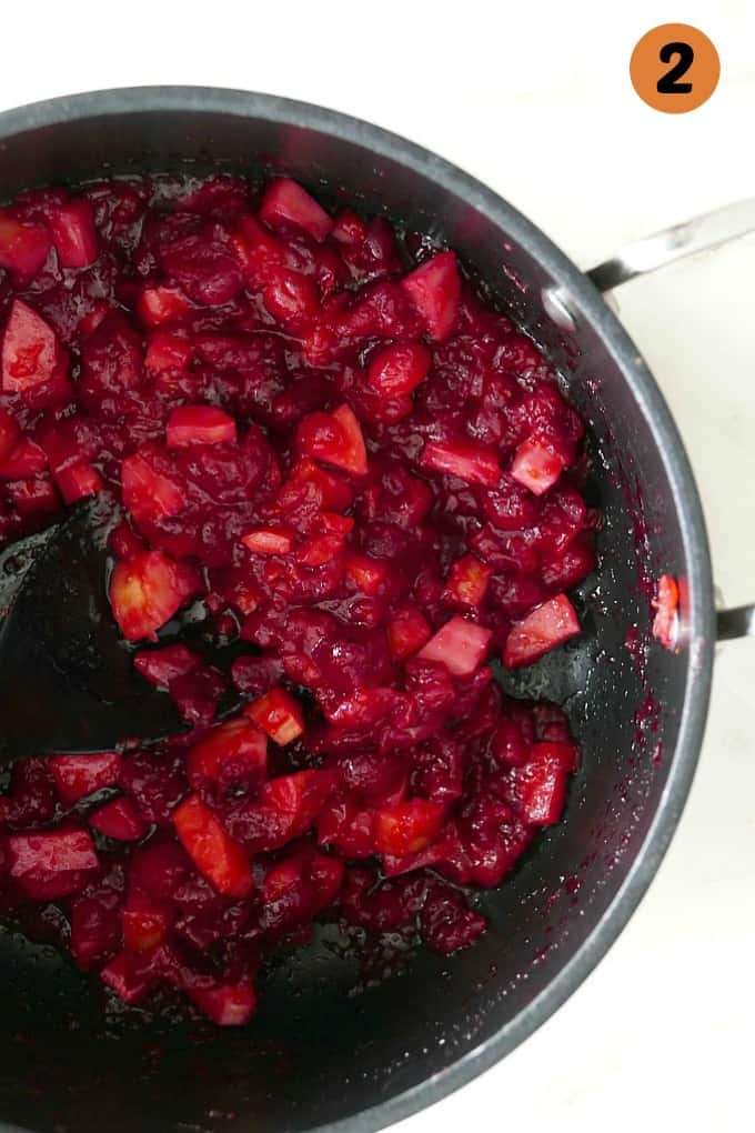 cooked cranberries and parsnips in a large black pot