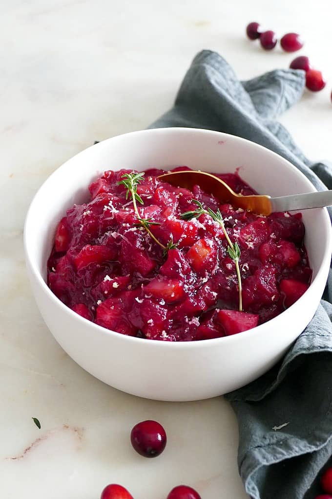 low sugar cranberry sauce with parsnips in a white bowl on a blue napkin