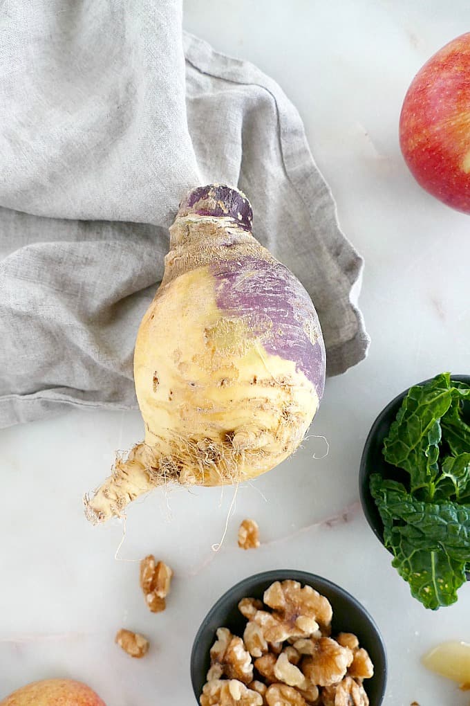 rutabaga on top of a napkin on a counter next to salad ingredients