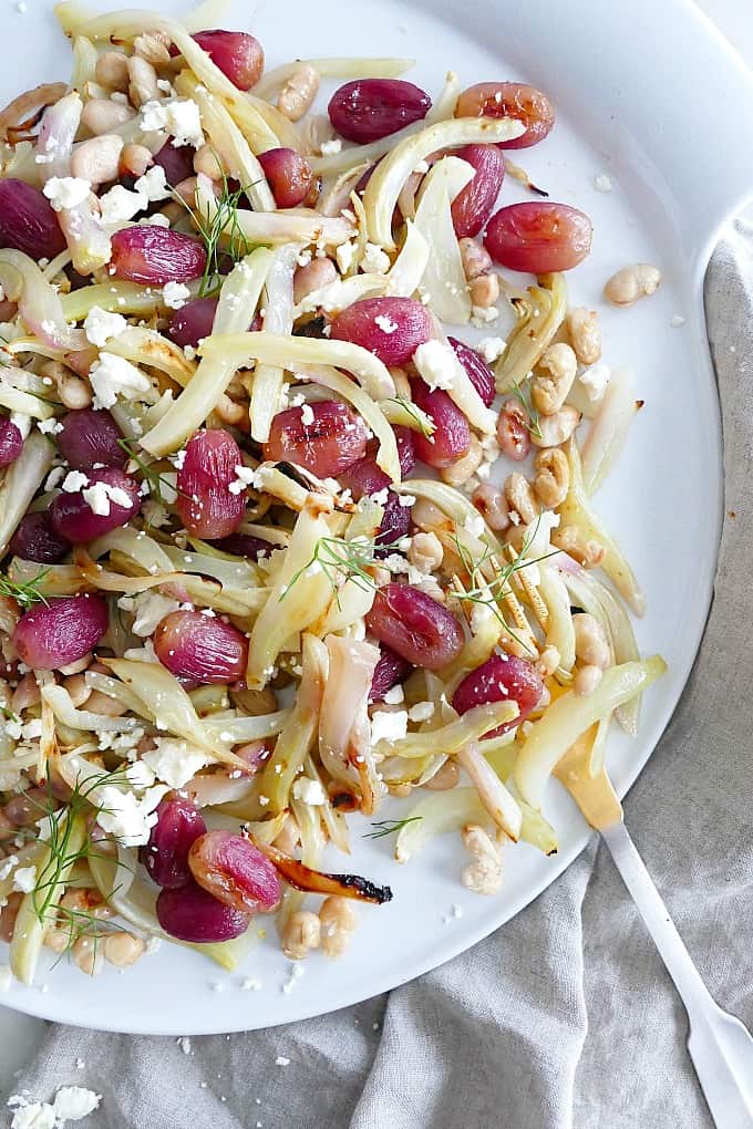 a close-up shot of warm fennel salad on a circular white plate