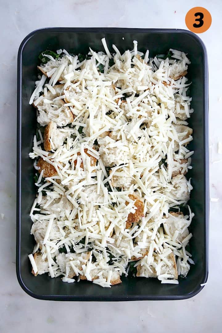 kale, shallots, sourdough bread cubes, and shredded cheese in a 9x13 baking dish