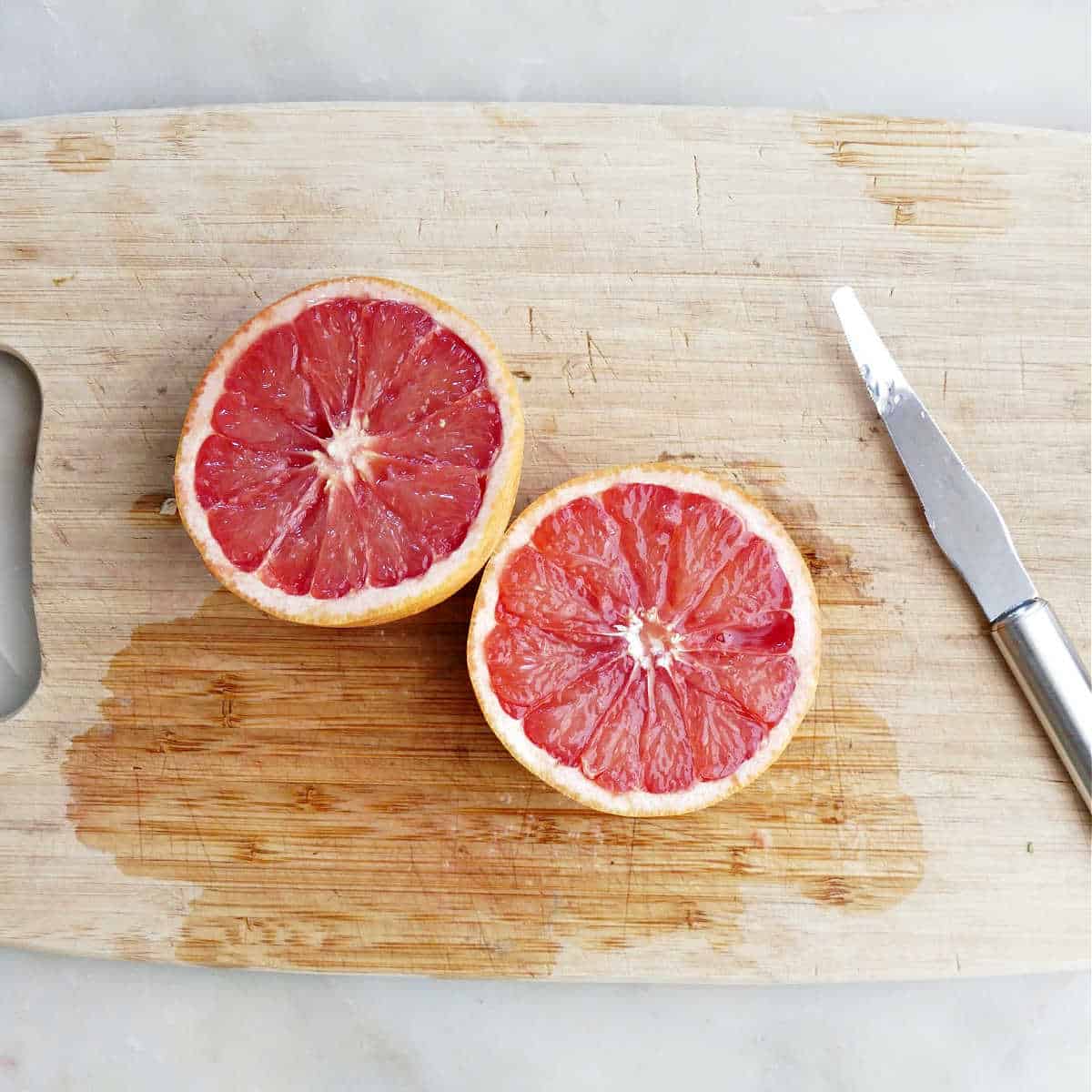 grapefruit after being segmented with a grapefruit knife on a cutting board