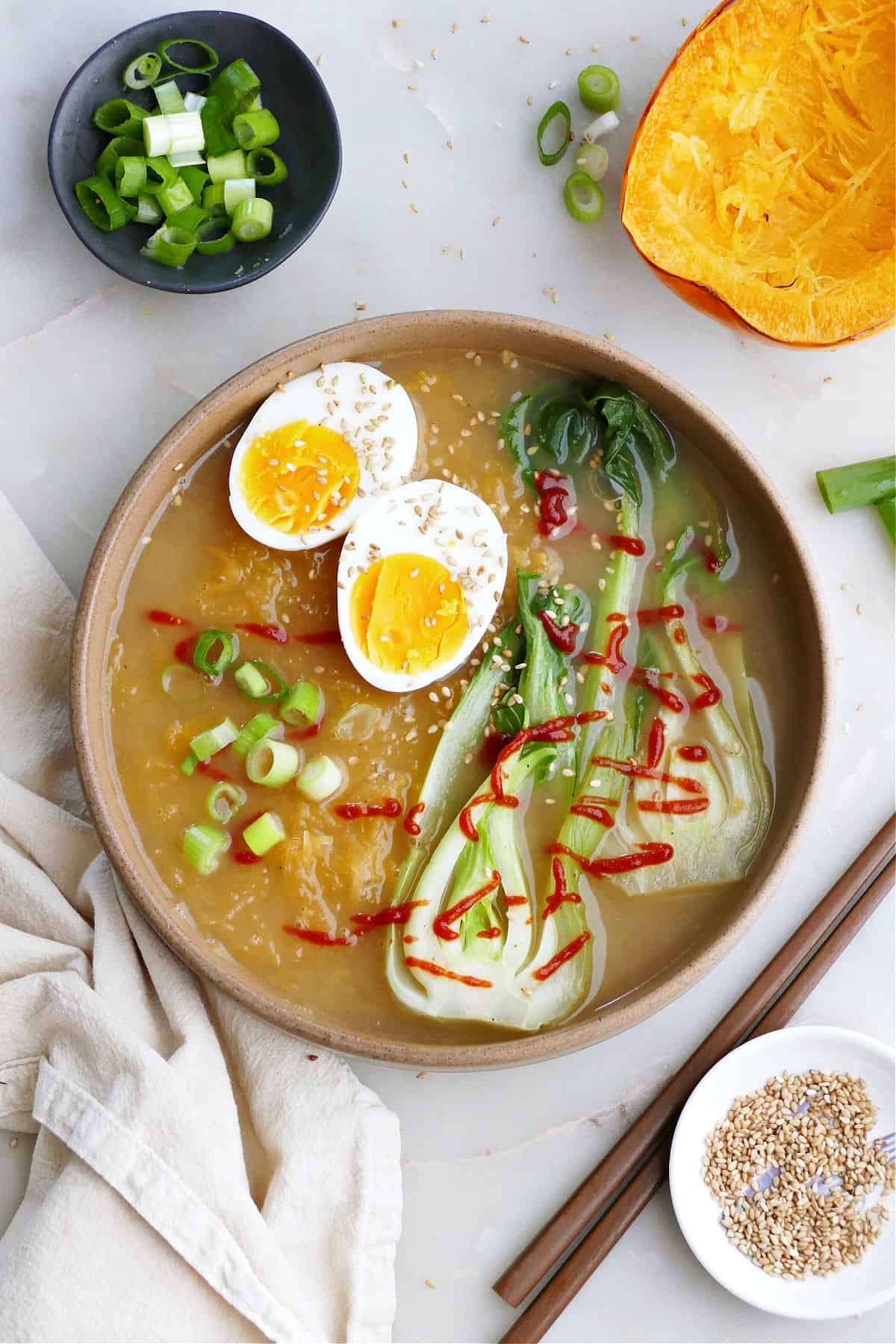 Spaghetti Squash Ramen with a sliced boiled egg and bok choy in a serving bowl