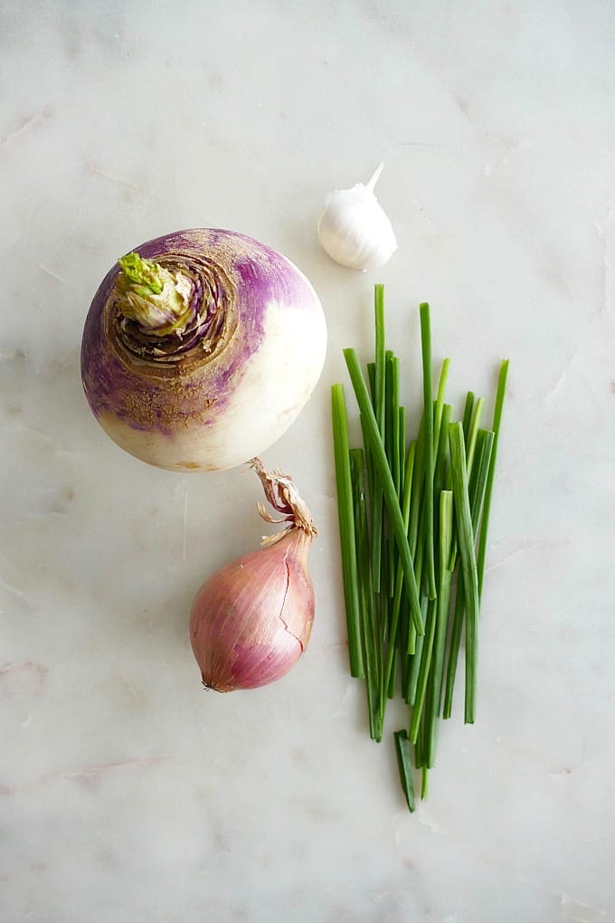 a turnip, shallot, garlic clove, and chives