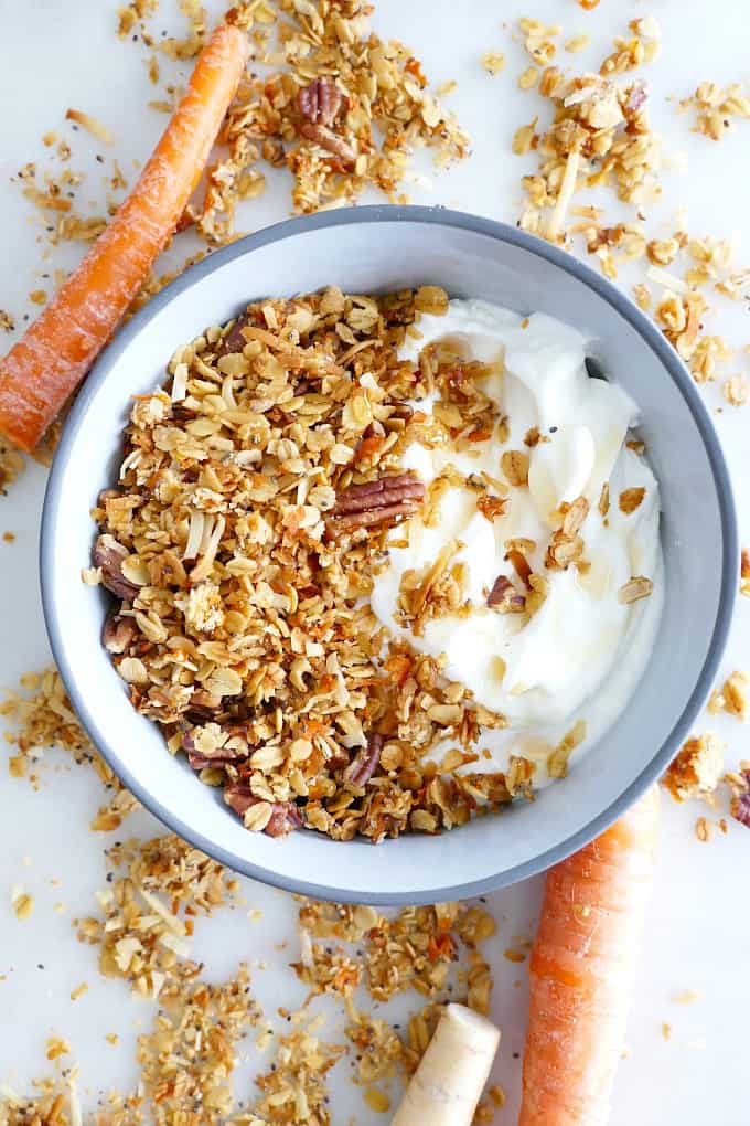 blue bowl with carrot cake granola and plain yogurt on a counter
