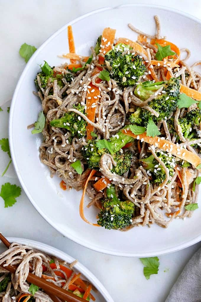 close up Peanut Soba Noodles with Roasted Broccoli and shaved carrots on a platter