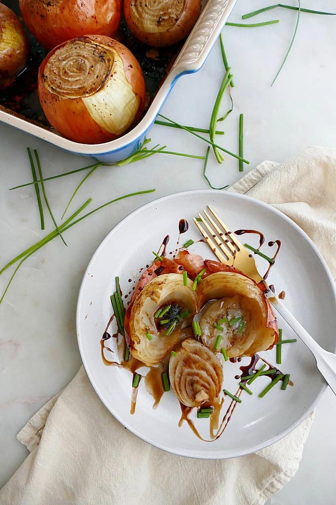 a whole roasted onion with balsamic and chives