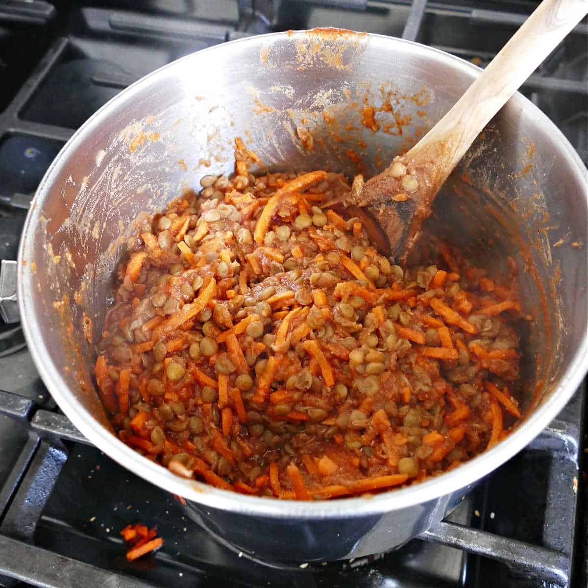 barbecue lentils and carrots cooking in sauce in a saucepan