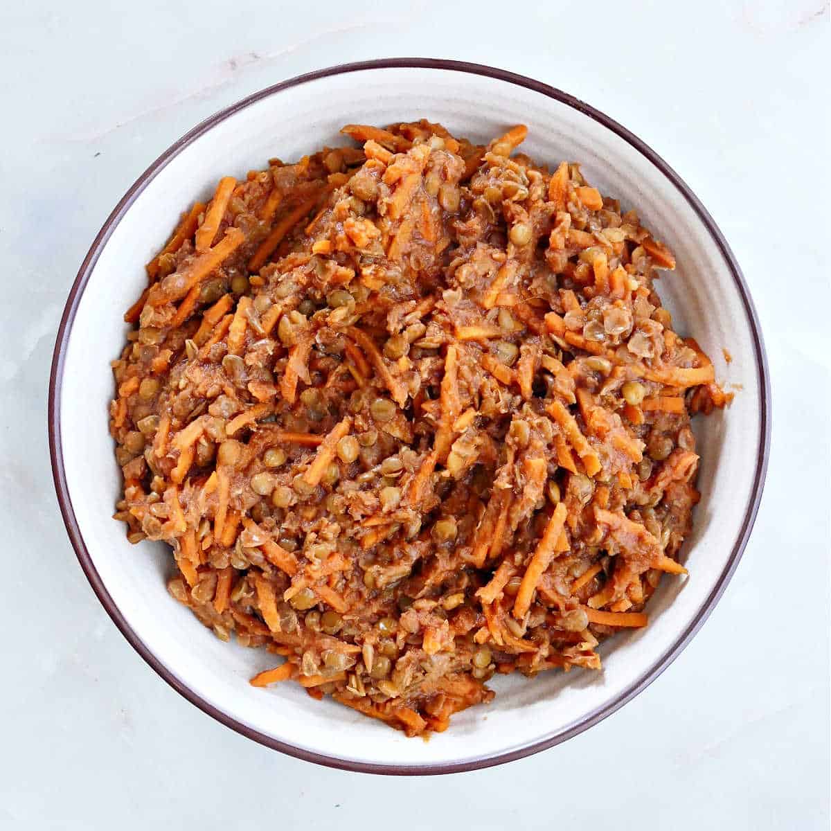 cooked barbecue lentils and carrots in a bowl on a counter