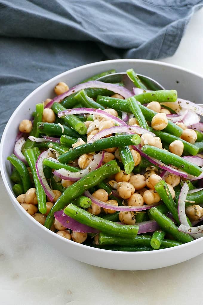 side view of italian marinated green bean salad in a serving bowl