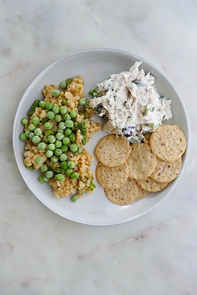 plate with vegetable risotto, chicken salad, crackers