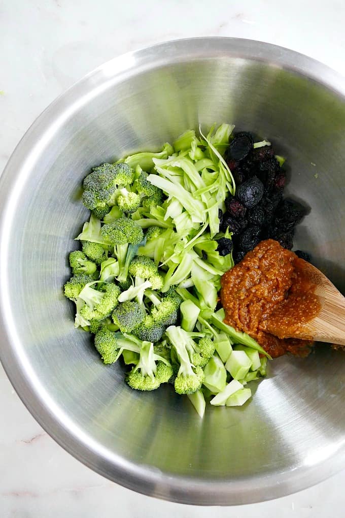 ingredients for broccoli salad in a mixing bowl