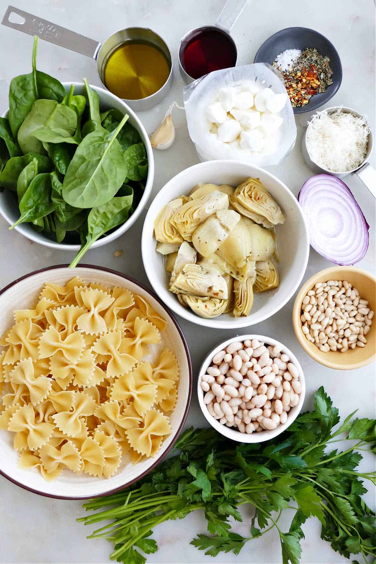 pasta salad with spinach, artichoke, and mozzarella on a platter