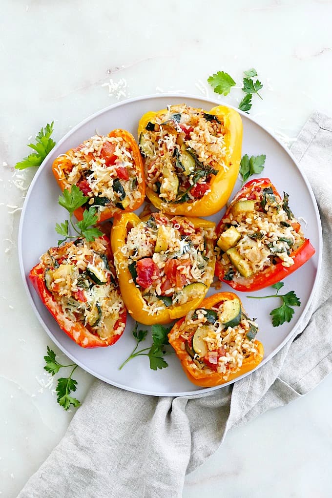 six Italian stuffed peppers on a serving dish