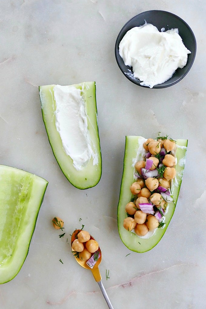 cucumber boats on a counter next to Greek yogurt