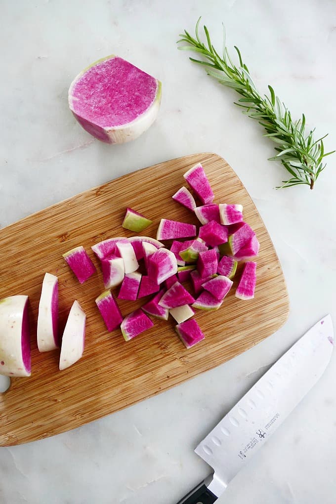 watermelon radishes diced on a cutting board