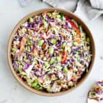 cabbage salad with cashews and sesame dressing in a bowl on a counter