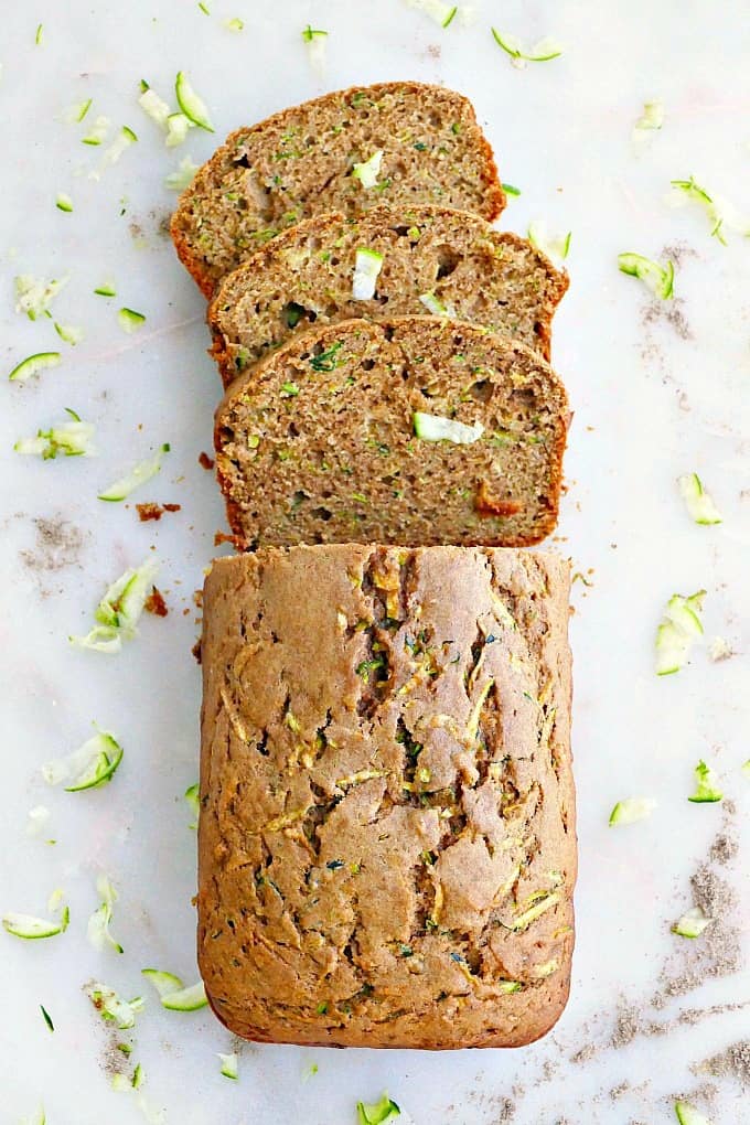olive oil zucchini bread with three slices on a counter