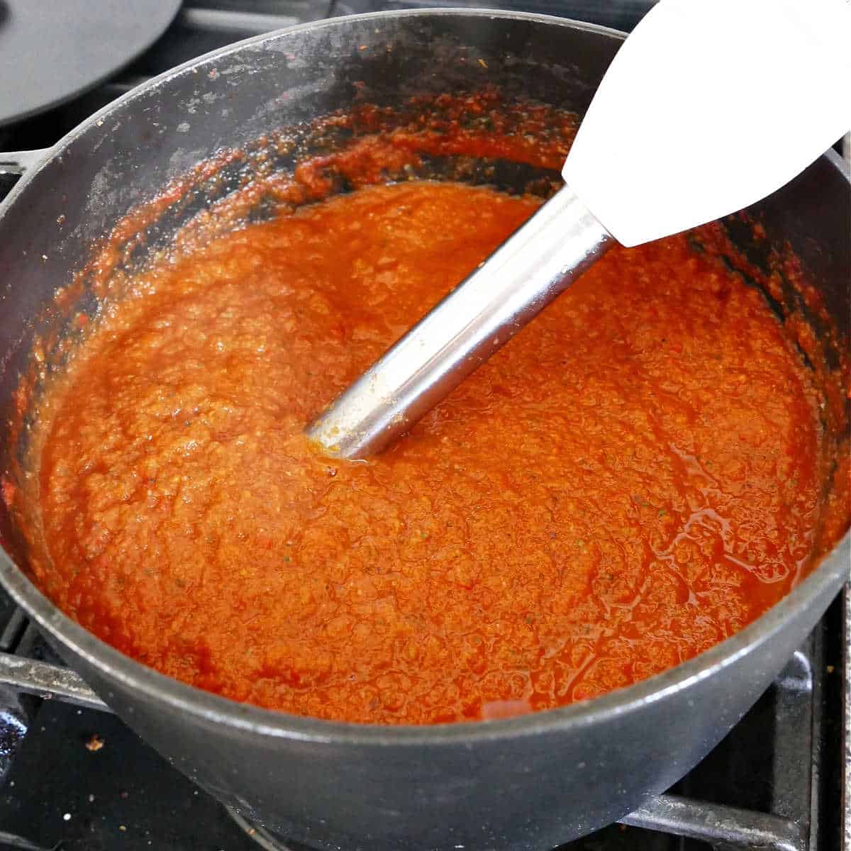 veggie tomato sauce pureed with an immersion blender in a large pot