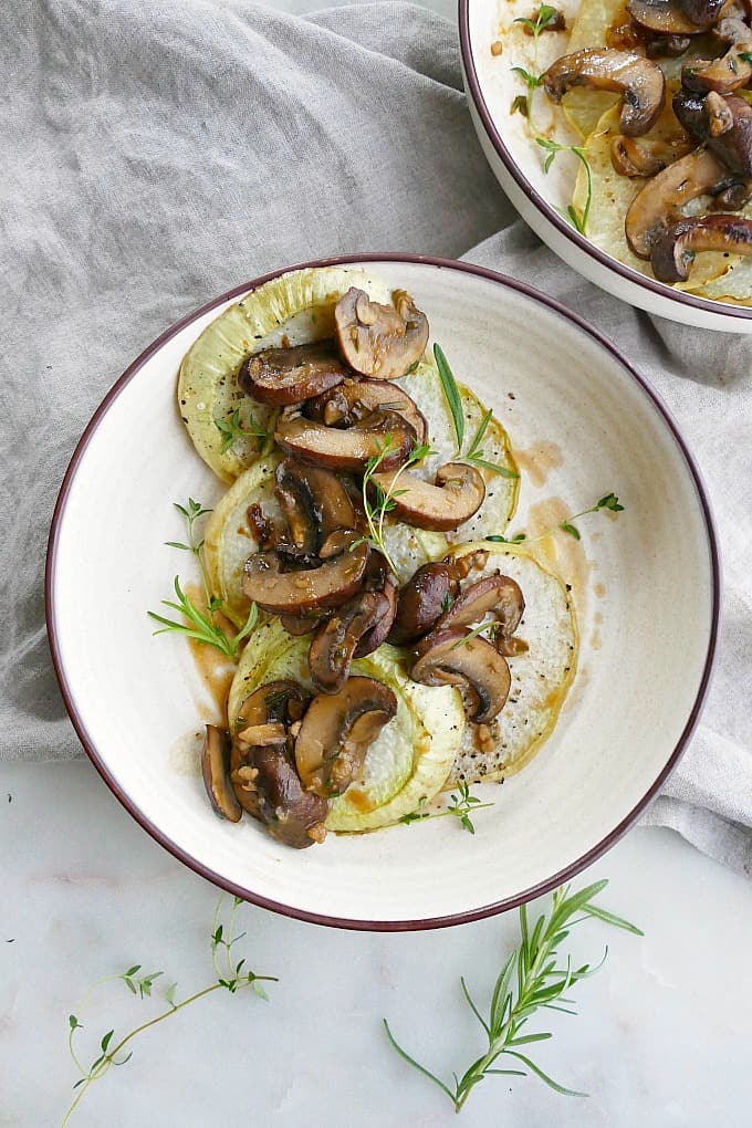 kohlrabi steaks with mushroom sauce on a serving dish