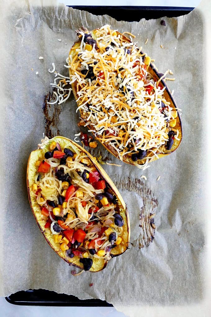 stuffed spaghetti squash on a baking sheet