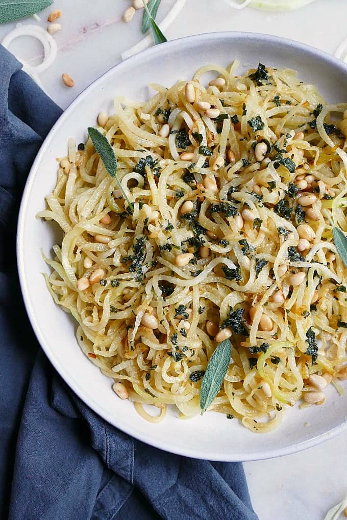 kohlrabi noodles and pine nuts in a bowl