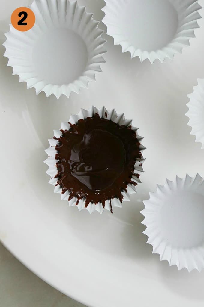 close up of one mini cupcake liner with melted chocolate
