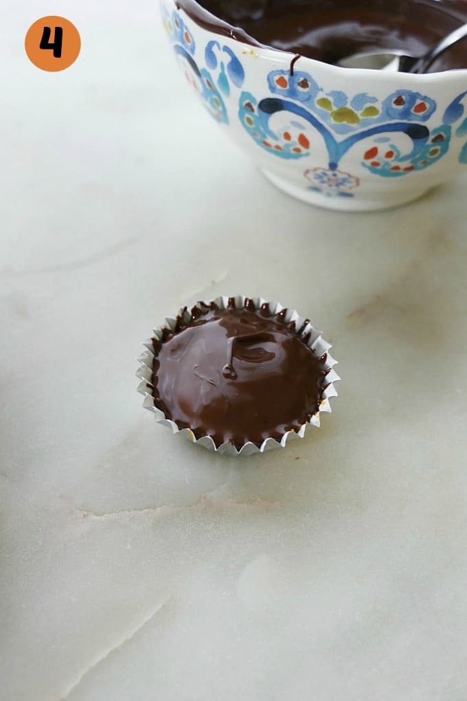 a mini cupcake liner with chocolate and pumpkin peanut butter filling
